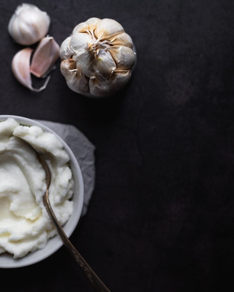 bowl of toum garlic sauce and head of garlic