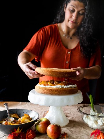 Woman assembling layer cake