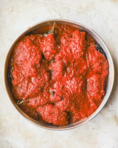 Tray with eggplant covered in tomato sauce