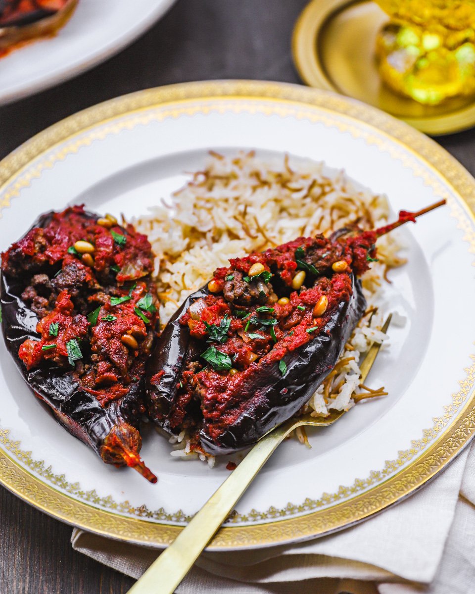 Stuffed eggplant on a bed of rice on a plate