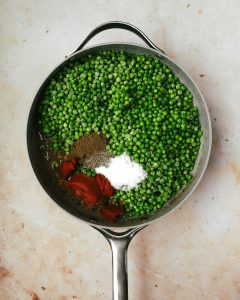 skillet with peas and seasonings