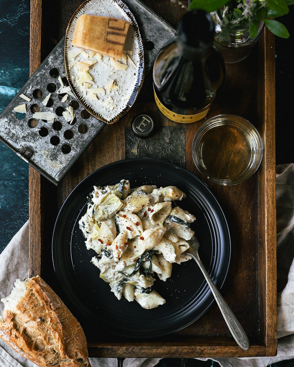 Plate of pasta, grated cheese and wine