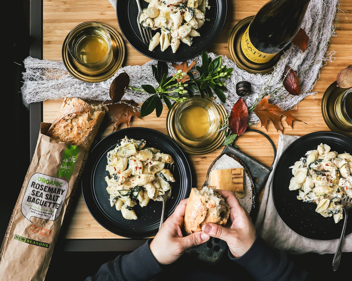 Spread of plates of pasta, wine and bread