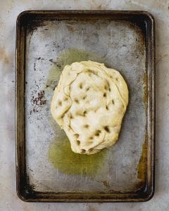 dough on sheet pan with olive oil