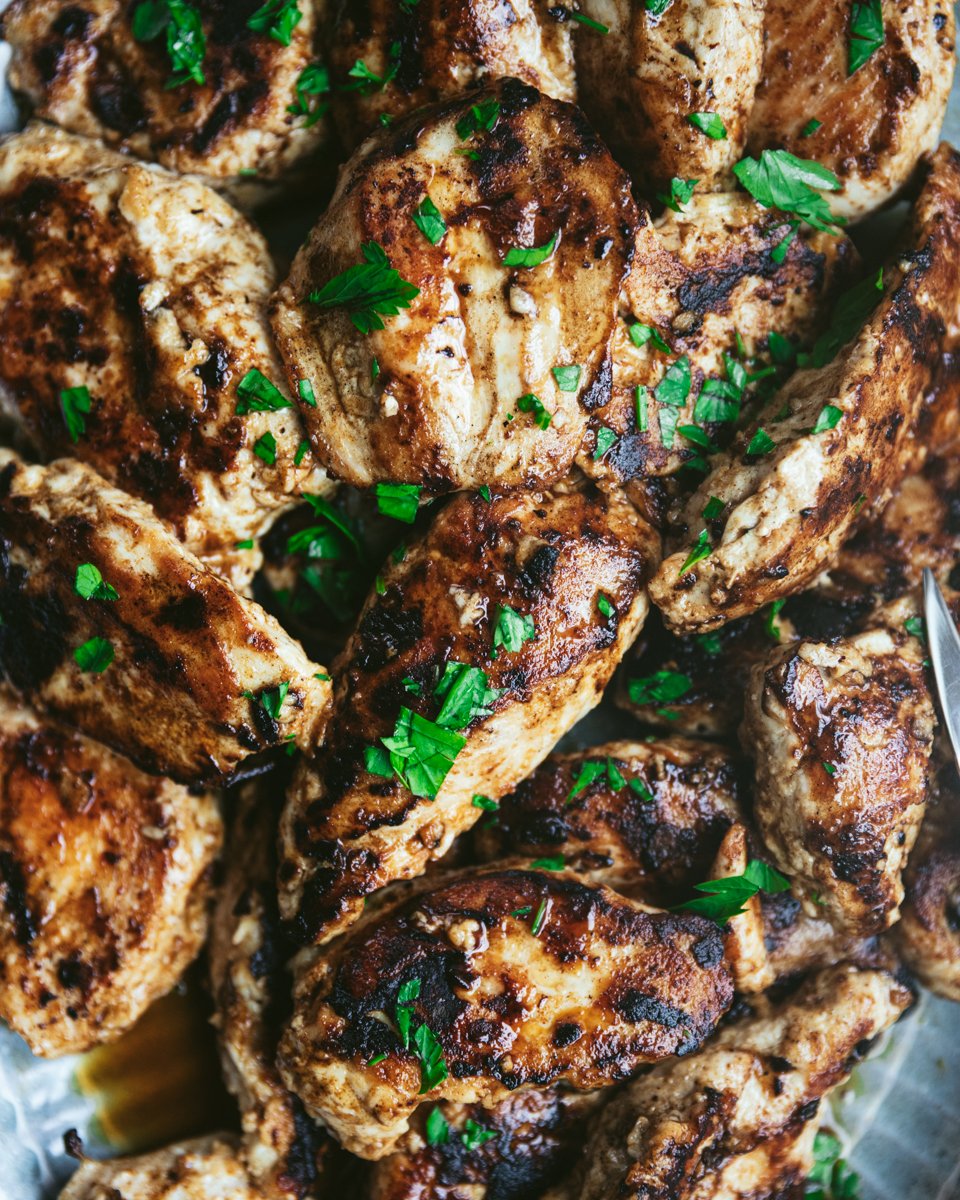 grilled chicken breast on a platter, close up