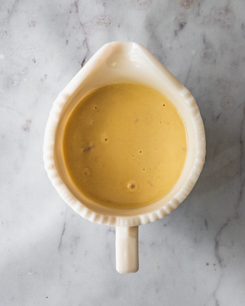 Top view of tahini sauce in a spouted pourer