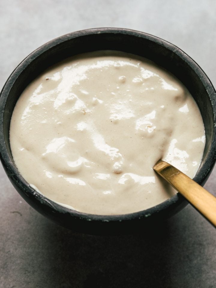 tahini sauce in a bowl with spoon