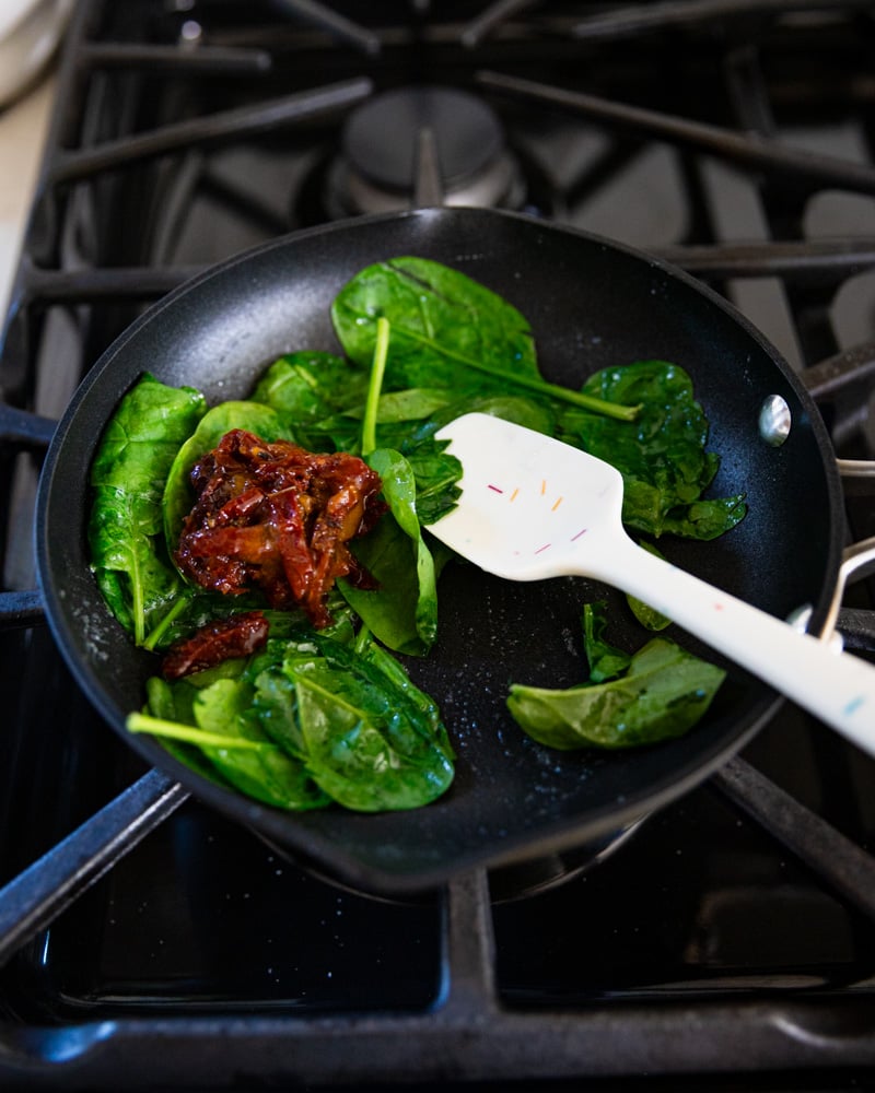 spinach and Calabrian chili in skillet